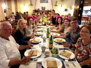 Group of people having dinner at a restaurant and eating crepes.