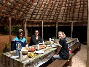 three students sit at a table for dinner