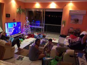 Four people inside their home in the lounge room