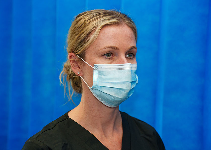 Close-up photo of nurse wearing a surgical mask.