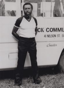 Koiki stands beside the Black Community School Bus