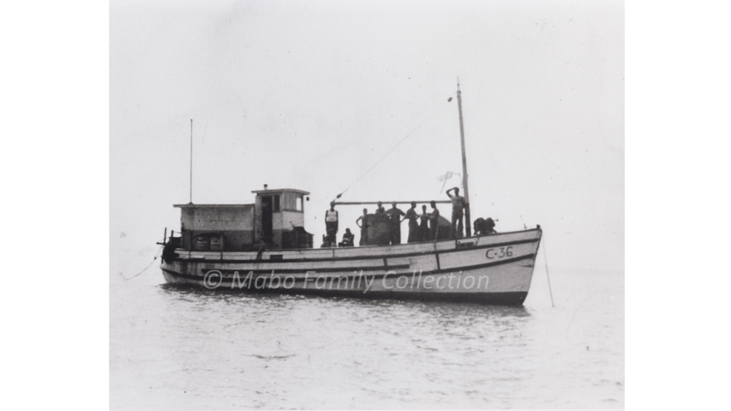 Pearling boat with men standing on the deck