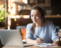 Woman with headphones studying on her laptop