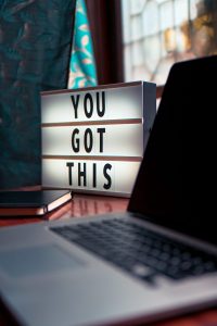 latop with sign on desk that says 'you got this'